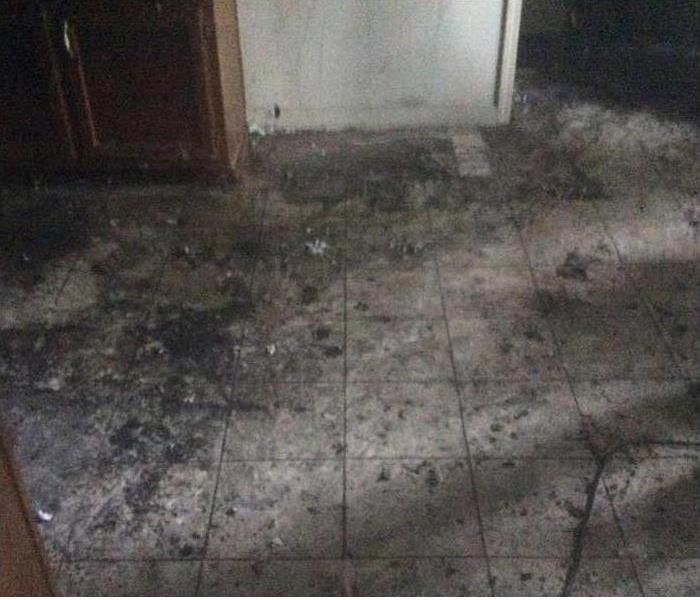 cleared of the charred debris, the floor is now just dirty with soot