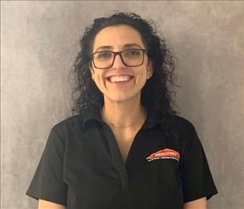 female employee with black hair and a big smile