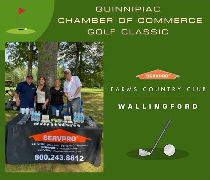 4 SERVPRO employees at a table at a golf course