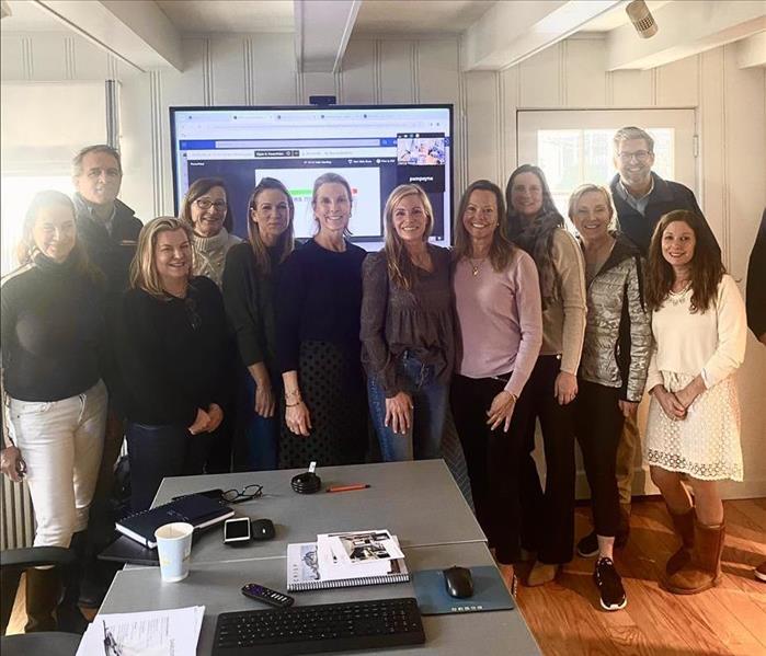 group of people standing in an office