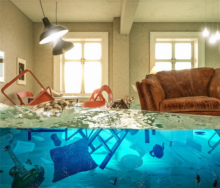 a flooded living room with the homeowners possessions floating around everywhere