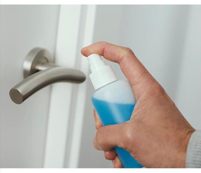 hand spray a silver door knob