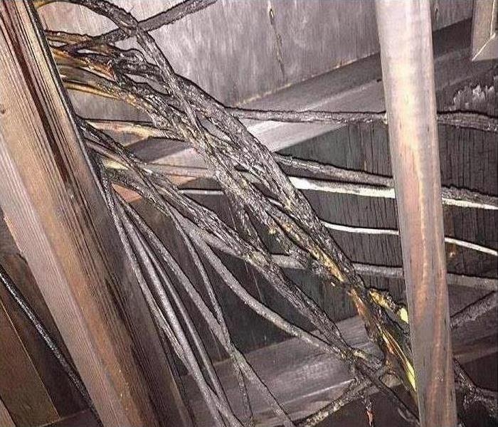 Damaged wiring that caused a fire in this attic